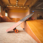 asian women surf skate or skates board indoor beautiful summer day. sport activity lifestyle concept