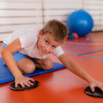 children training with exercise gliders, improving balance and coordination skills