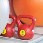 kettlebells and fitballs on a stand in fitness club. sport equipment. healthy lifestyle,