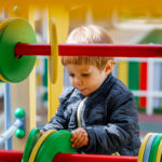 little boy playing on the playground. summer vacation