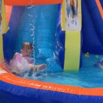little girl on an inflatable water slide in summer 2023 11 27 05 17 52 utc