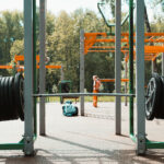 outdoor sports ground with complex of horizontal bars and exercise equipment in park, outdoors. selective focus on training rod with disks