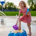 small child playing at splash pad playground in su 2023 11 27 05 19 00 utc