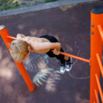 street workout on a horizontal bar in the school park.
