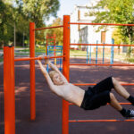 street workout on a horizontal bar in the school park.