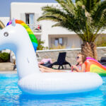 two little kids playing in the swimming pool